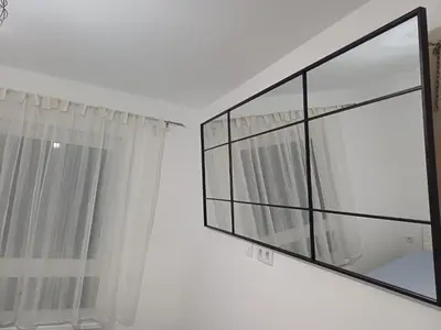 a bathroom with a window and a mirror at Apartman Kratos in Banja Luka