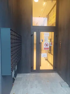 a door to a building with a no smoking sign on it at Apartman Kratos in Banja Luka