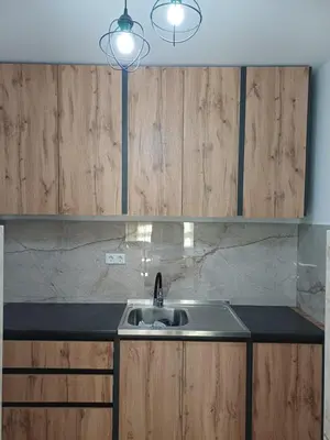 a kitchen with a sink and wooden cabinets at Apartman Kratos in Banja Luka