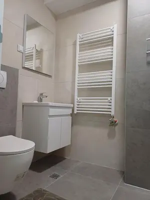 a bathroom with a toilet and a sink and a mirror at Apartman Kratos in Banja Luka