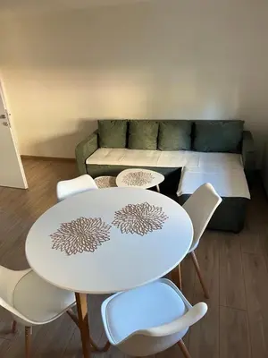 a living room with a table and chairs and a couch at Apartman Zvjezdica in Banja Luka