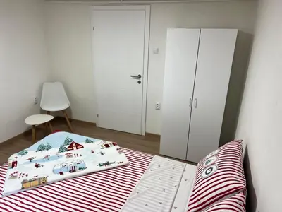 a bedroom with a bed and a closet at Apartman Zvjezdica in Banja Luka