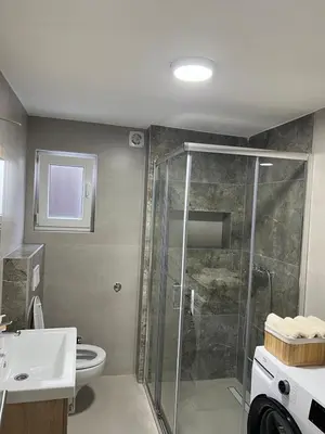 a bathroom with a shower and a toilet and a sink at Apartman Zvjezdica in Banja Luka