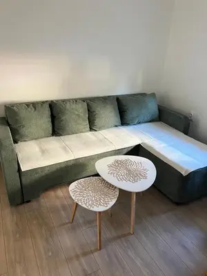 a living room with a couch and two tables at Apartman Zvjezdica in Banja Luka