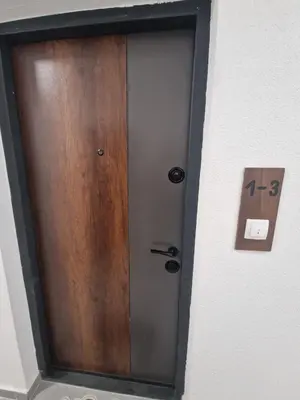 a door in a wall with a clock on it at Apartman Damjan in Banja Luka