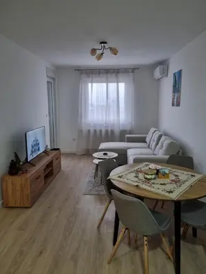a living room with a couch and a table at Apartman Mila in Doboj