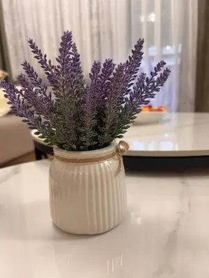 a vase with purple flowers in it on a table at Taša 1 in Banja Luka