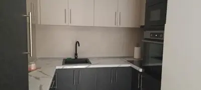 a kitchen with white cabinets and a sink at Taša 1 in Banja Luka