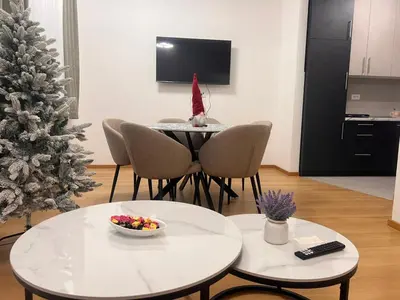 a living room with a christmas tree and a table at Taša 1 in Banja Luka