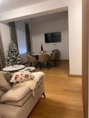 a living room with a christmas tree and a couch at Taša 1 in Banja Luka