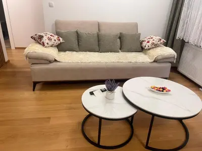 a living room with two tables and a couch at Taša 1 in Banja Luka