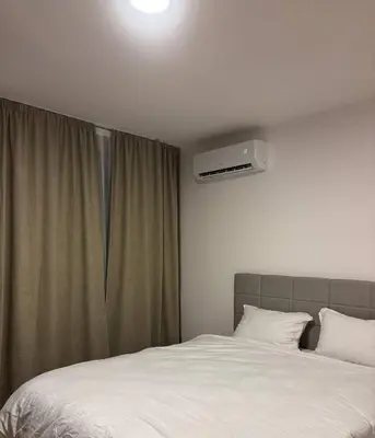 a bedroom with a white bed and a window at Apartman S52 in Doboj