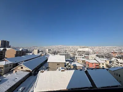 an aerial view of a city with snow covered roofs at Apartman S52 in Doboj