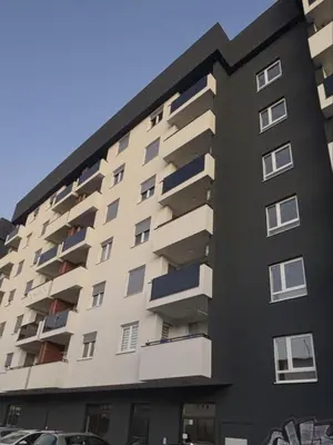 a building with balconies on the side of it at Apartman S52 in Doboj