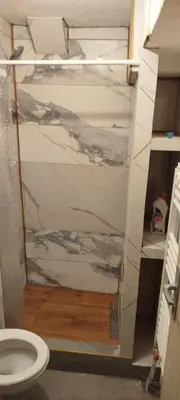 a bathroom with a glass door with a toilet at Apartman Ani in Hiseti