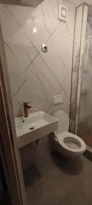 a bathroom with a toilet and a sink at Apartman Ani in Hiseti