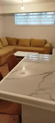 a living room with a couch and a table at Apartman Ani in Hiseti