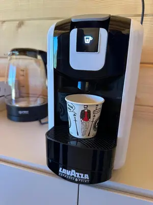 a coffee maker with a cup on a shelf at Suncatcher Djurdjevic Apartmani in Banja Luka