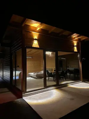 a room with a large glass window with a bedroom at Suncatcher Djurdjevic Apartmani in Banja Luka