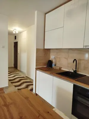 a kitchen with white cabinets and a sink at Ela in Banja Luka