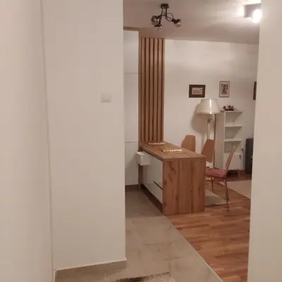 a living room with a desk and a chair at Apartman Ella in Železnička Stanica Incel
