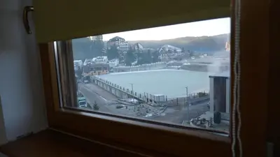 a window with a view of a body of water at Apartmani Flocke Vlašić in Šišava