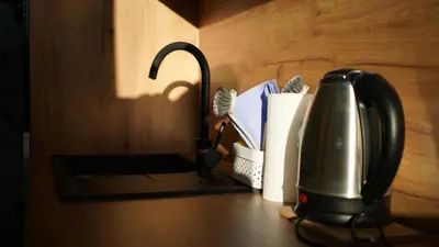 a kitchen counter with a tea kettle and paper towels at Apartmani Flocke Vlašić in Šišava