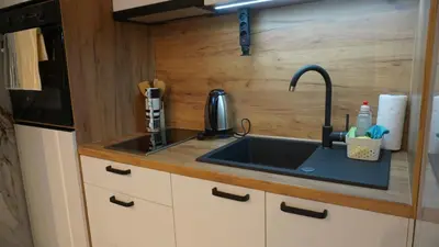 a kitchen with a sink and a microwave at Apartmani Flocke Vlašić in Šišava