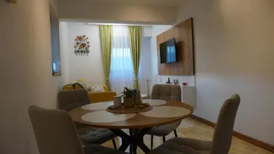a living room with a dining room table and chairs at Apartmani Flocke Vlašić in Šišava