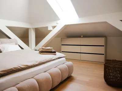 a attic bedroom with a bed and a skylight at PENTHOUSE ROYA BiHAC in Bihać