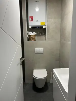 a bathroom with a white toilet and a sink at briliNIGHT in Banja Luka