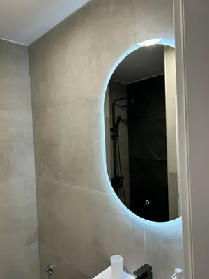 a bathroom with a mirror and a sink at briliNIGHT in Banja Luka