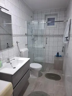 a bathroom with a toilet and a shower and a sink at Studio apartman KONAK in Kupres