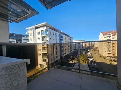 an apartment balcony with a view of a city at City Place Apartment in Banja Luka