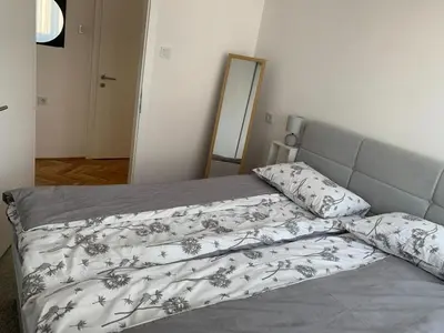 a bed with a blanket and pillows in a bedroom at Apartment Vilsonova in Banja Luka