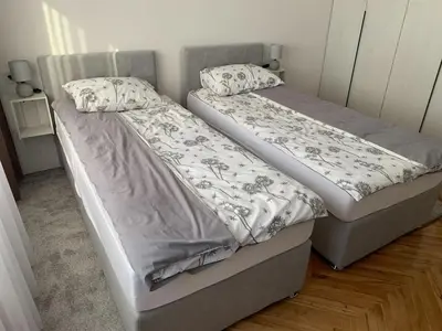 two beds sitting next to each other in a bedroom at Apartment Vilsonova in Banja Luka