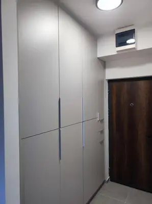 a room with white walls and a wooden door at Triton in Banja Luka