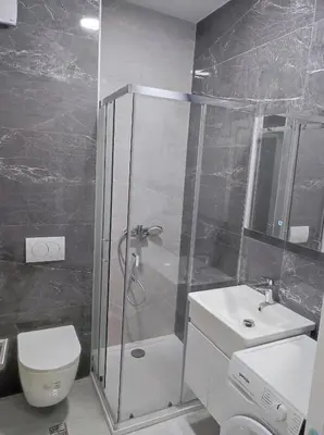 a bathroom with a shower and a toilet and a sink at Triton in Banja Luka