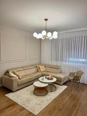 a living room with a couch and a table at Apartman GrandTrade by Termax in Banja Luka