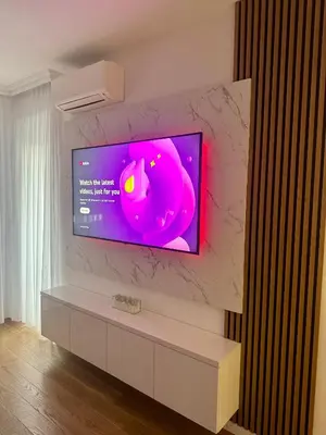 a television on a wall in a living room at Apartman GrandTrade by Termax in Banja Luka
