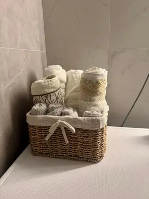 a basket of towels and towels on a table at Apartman GrandTrade by Termax in Banja Luka