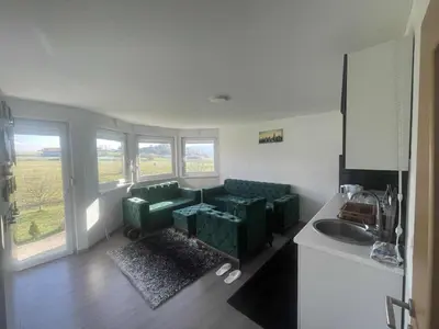 a living room with a couch and a sink at Zanesovici Jezero in Bugojno