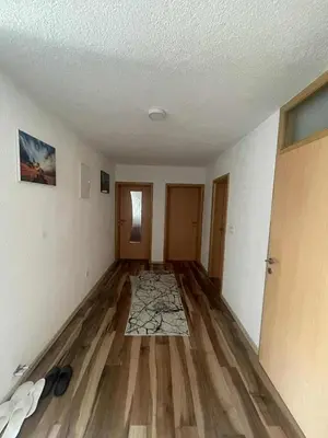 an empty room with wooden floors and white walls at Zanesovici Jezero in Bugojno