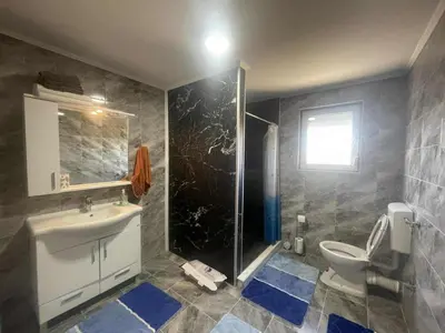 a bathroom with a toilet and a sink and a shower at Zanesovici Jezero in Bugojno