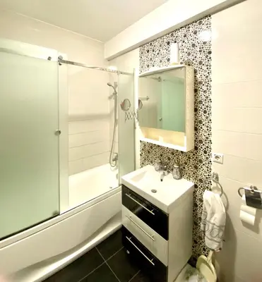 a bathroom with a shower and a sink and a mirror at Banjaluka in Banja Luka