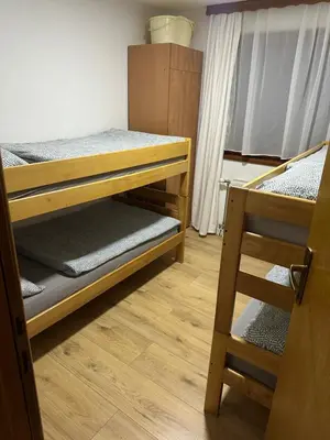 a room with two bunk beds and a ladder at Apartman Nina in Šišava