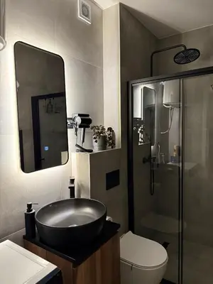 a bathroom with a black sink and a shower at CENTRAL SQUARE Tuzla in Tuzla