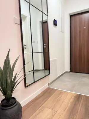 a hallway with a potted plant and a door at CENTRAL SQUARE Tuzla in Tuzla