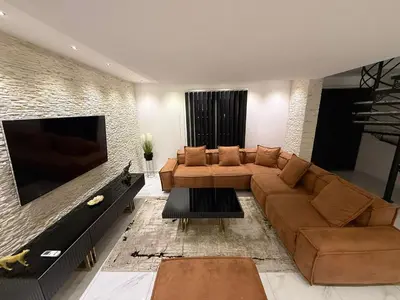 a living room with a couch and a large television at Villa Leah in Bihać