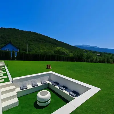 a backyard with a fire pit in the grass at Villa Leah in Bihać
